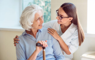 Happy woman sitting on bench with caregiver