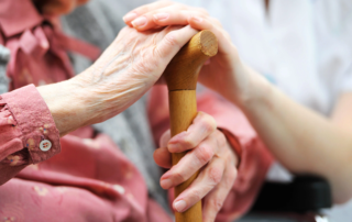 Closeup of hands over cane