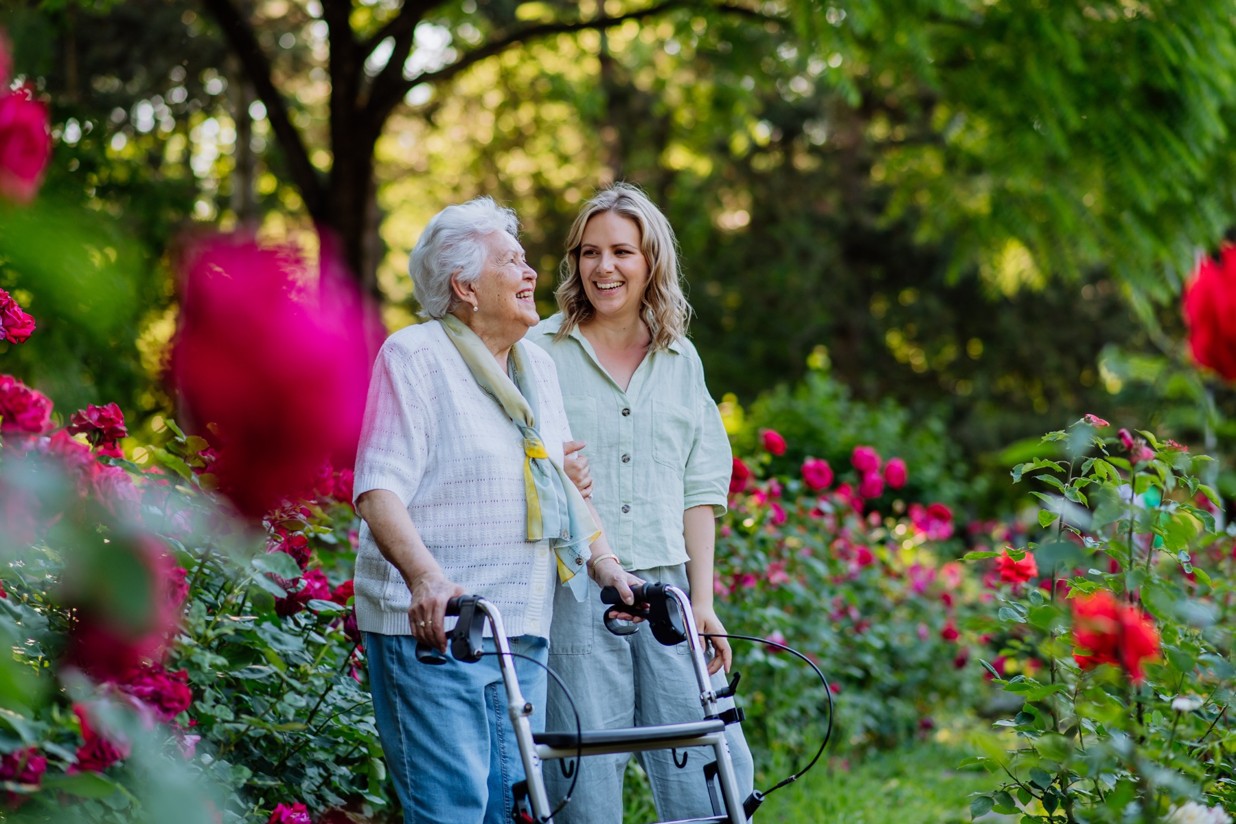 Woman walking with caregiver outdoors